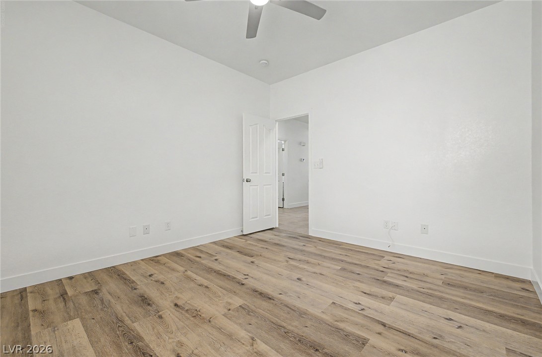 835 Entrada Ridge Avenue Henderson, NV 89012 - Photo 29 of 34 A well-lit bedroom with modern wood flooring offers comfortable living.