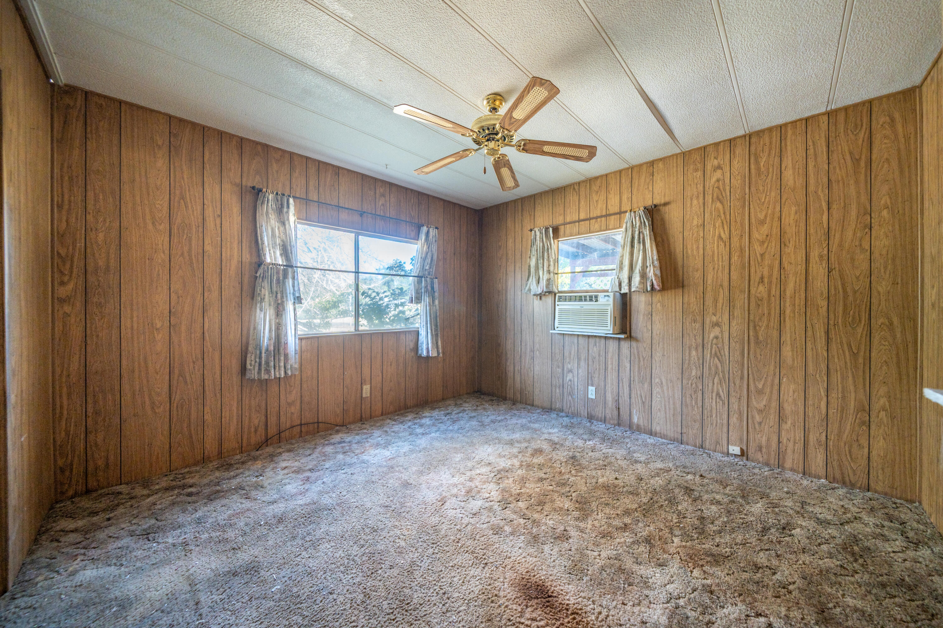18355 Benson Road Cottonwood, CA 96022 - Photo 9 of 18 an empty room with windows and fan