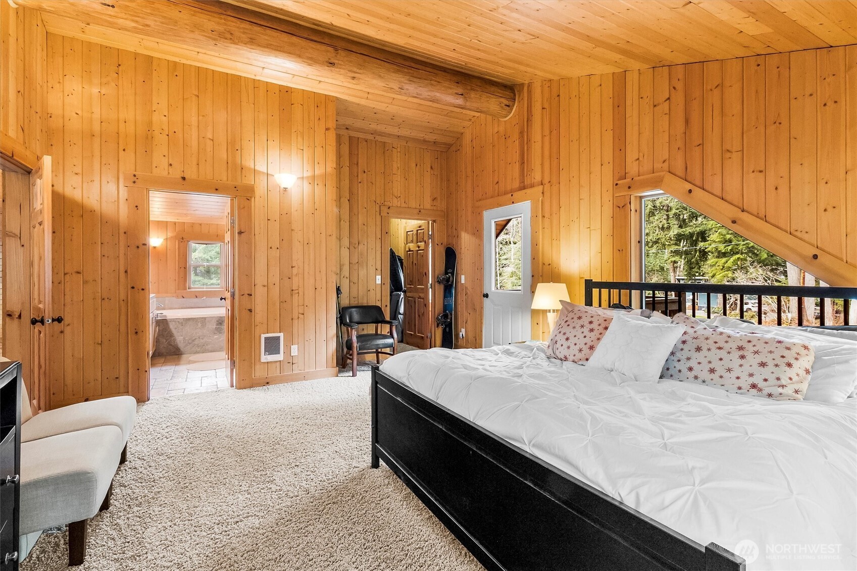 19040 Glacier Rim Drive Glacier, WA 98244 - Photo 19 of 40 a bedroom with a bed and a chandelier
