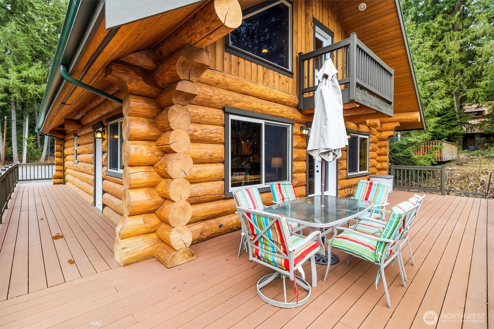 19040 Glacier Rim Drive Glacier, WA 98244 - Photo 24 of 40 a view of a patio with table and chairs with wooden floor and fence