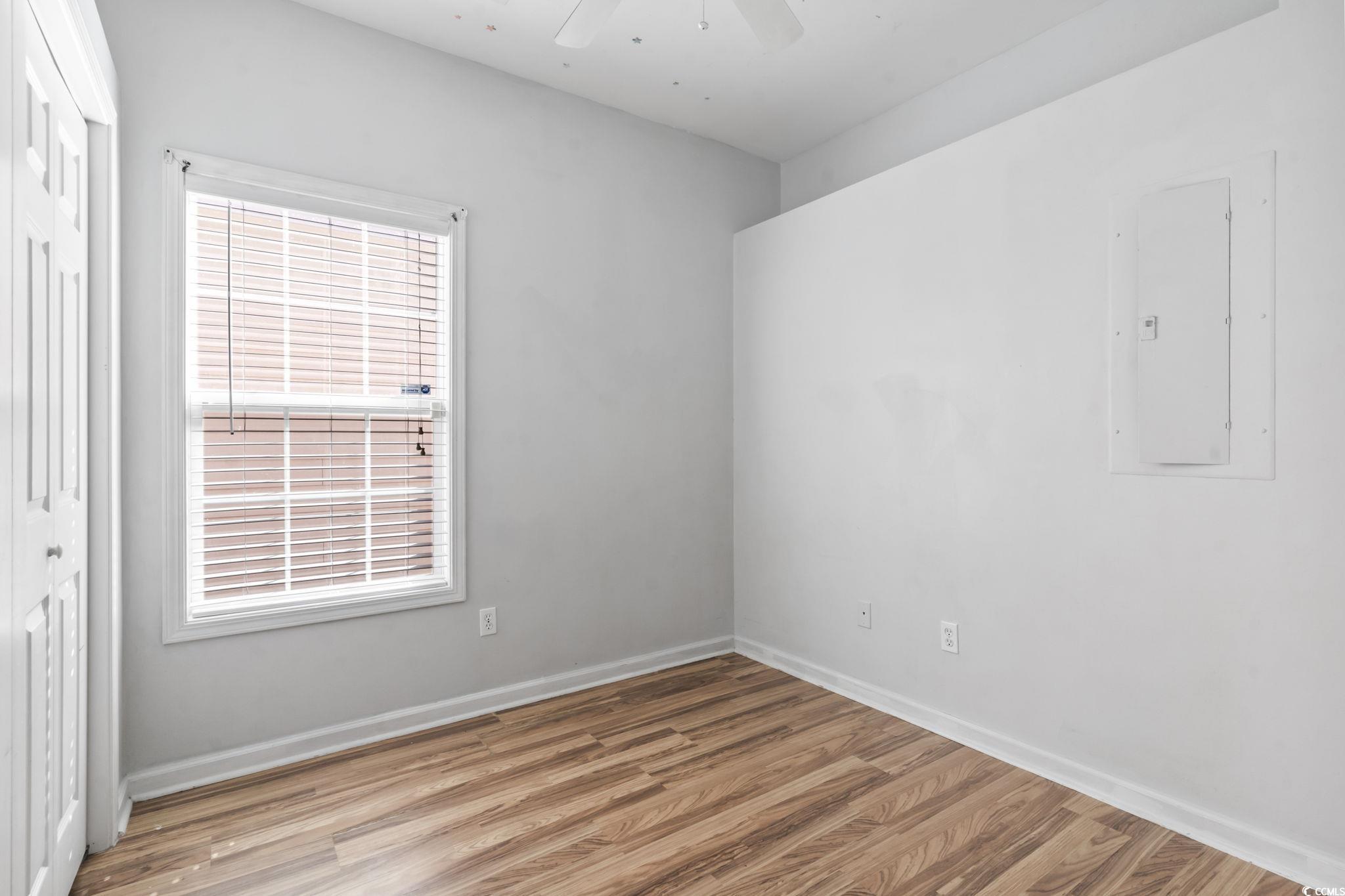 191 Addison Cottage Way Murrells Inlet, SC 29576 - Photo 11 of 28 Spare room featuring light wood-style flooring, electric panel, and a ceiling fan