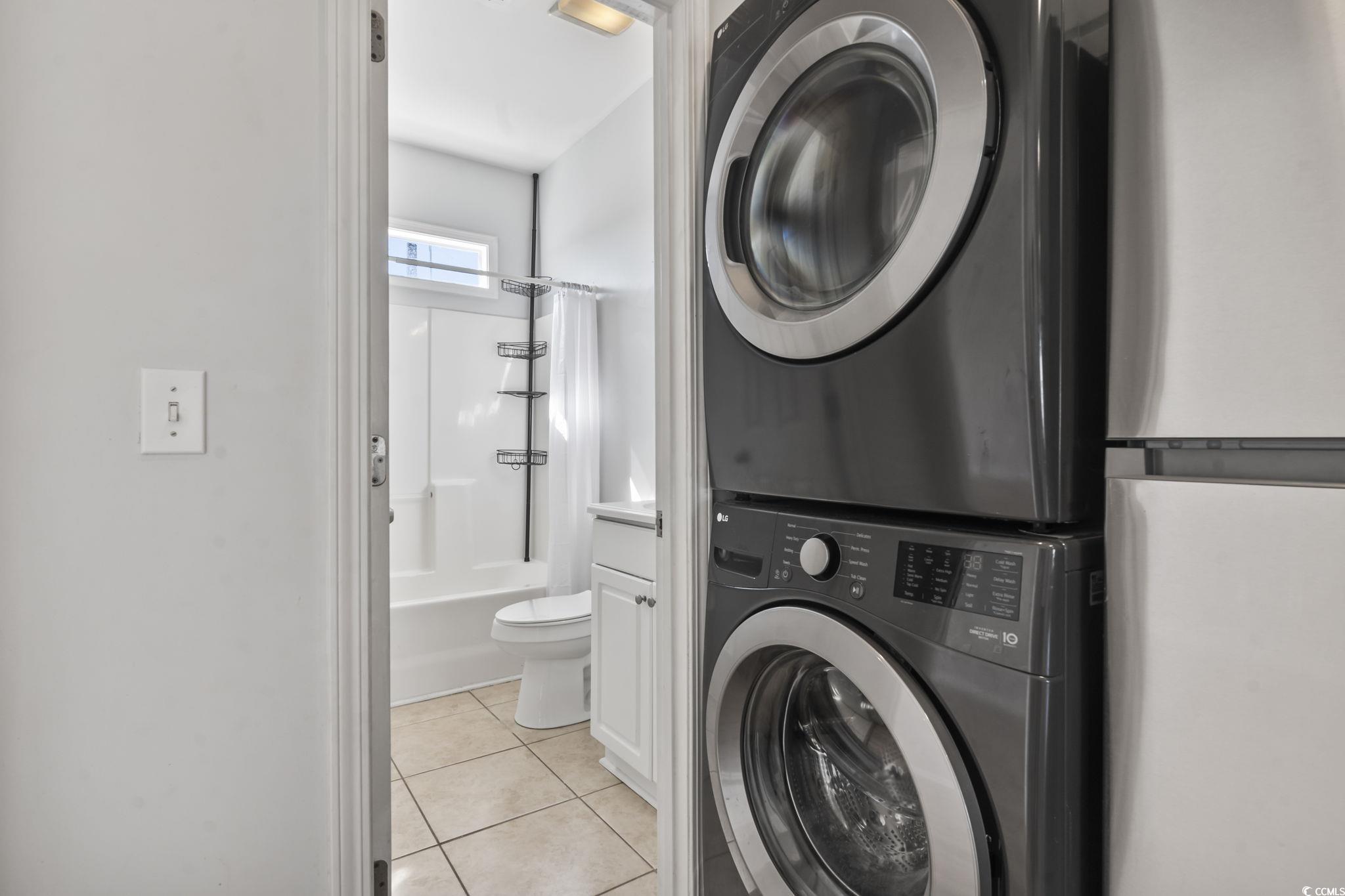 191 Addison Cottage Way Murrells Inlet, SC 29576 - Photo 14 of 28 Laundry area featuring light tile patterned floors and stacked washer / dryer