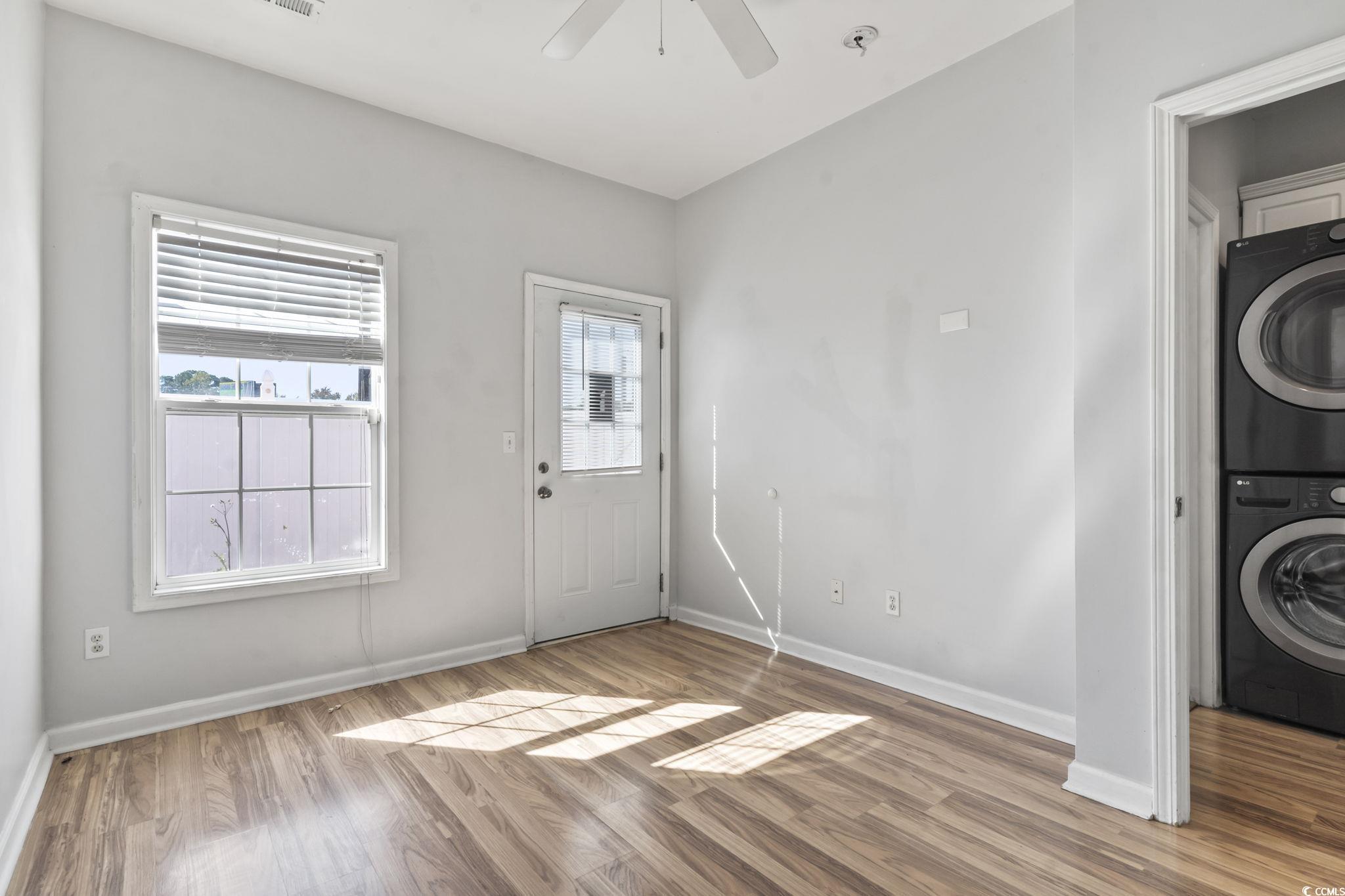 191 Addison Cottage Way Murrells Inlet, SC 29576 - Photo 19 of 28 Foyer with light wood-type flooring, stacked washer and clothes dryer, and a ceiling fan