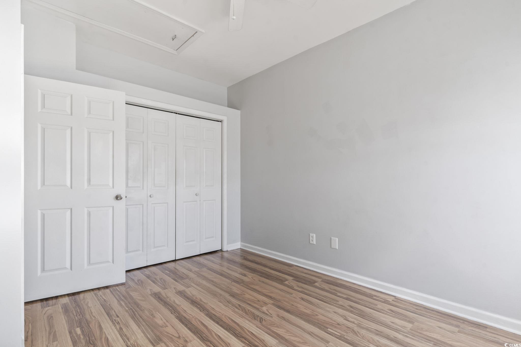 191 Addison Cottage Way Murrells Inlet, SC 29576 - Photo 20 of 28 Unfurnished bedroom with light wood finished floors, a closet, attic access, and ceiling fan