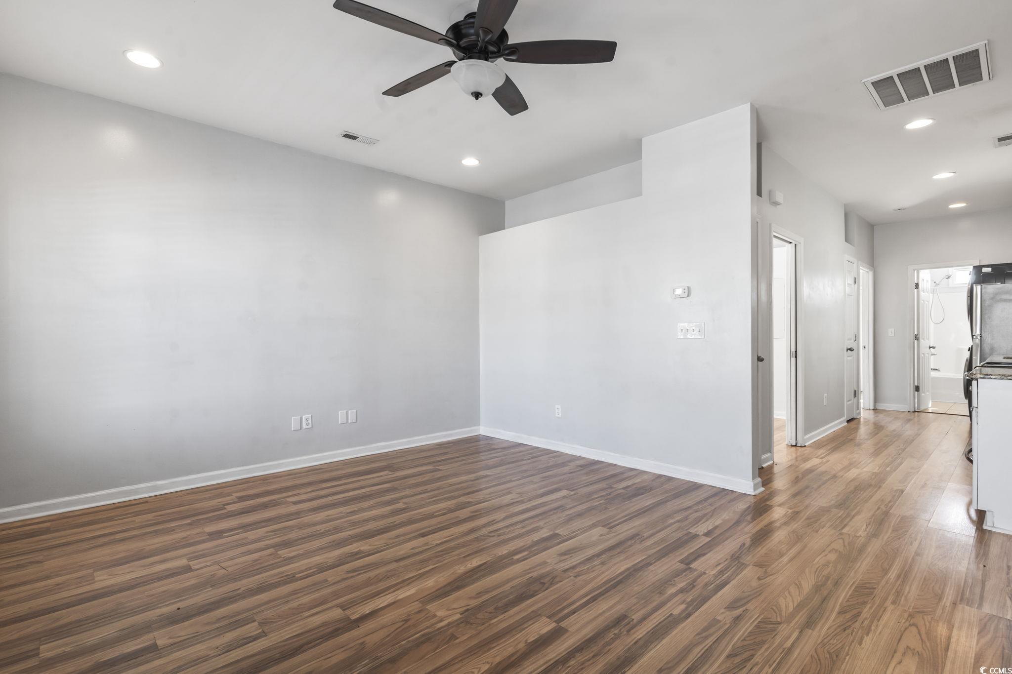 191 Addison Cottage Way Murrells Inlet, SC 29576 - Photo 6 of 28 Empty room with dark wood finished floors, recessed lighting, and a ceiling fan