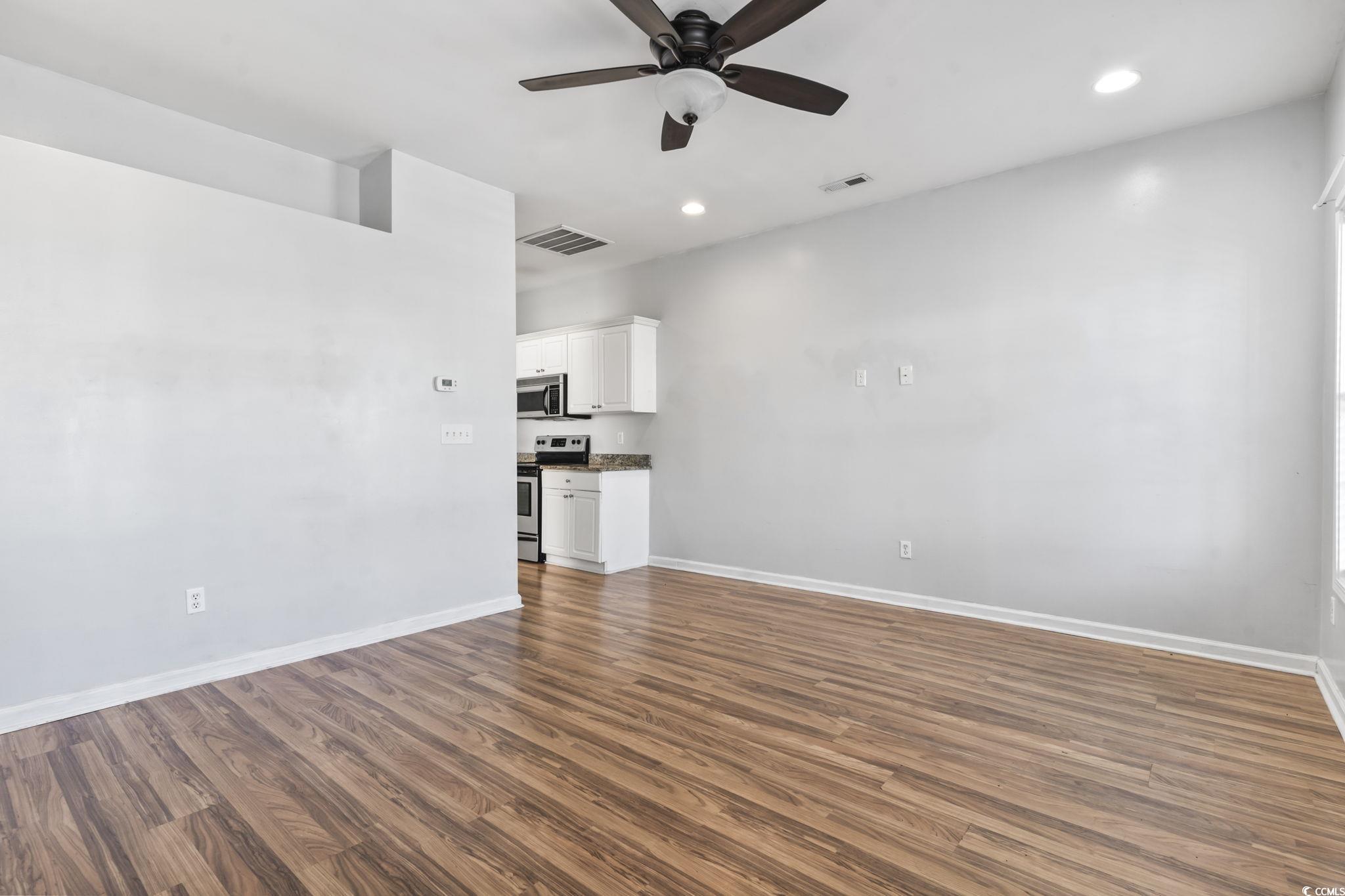 191 Addison Cottage Way Murrells Inlet, SC 29576 - Photo 7 of 28 Unfurnished living room with dark wood-type flooring, recessed lighting, and ceiling fan