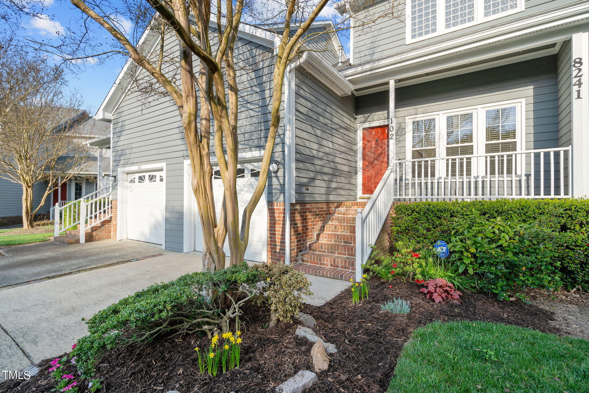 8241 Hempshire Place, Unit 102 Raleigh, NC 27613 - Photo 1 of 30 a front view of a house with garden