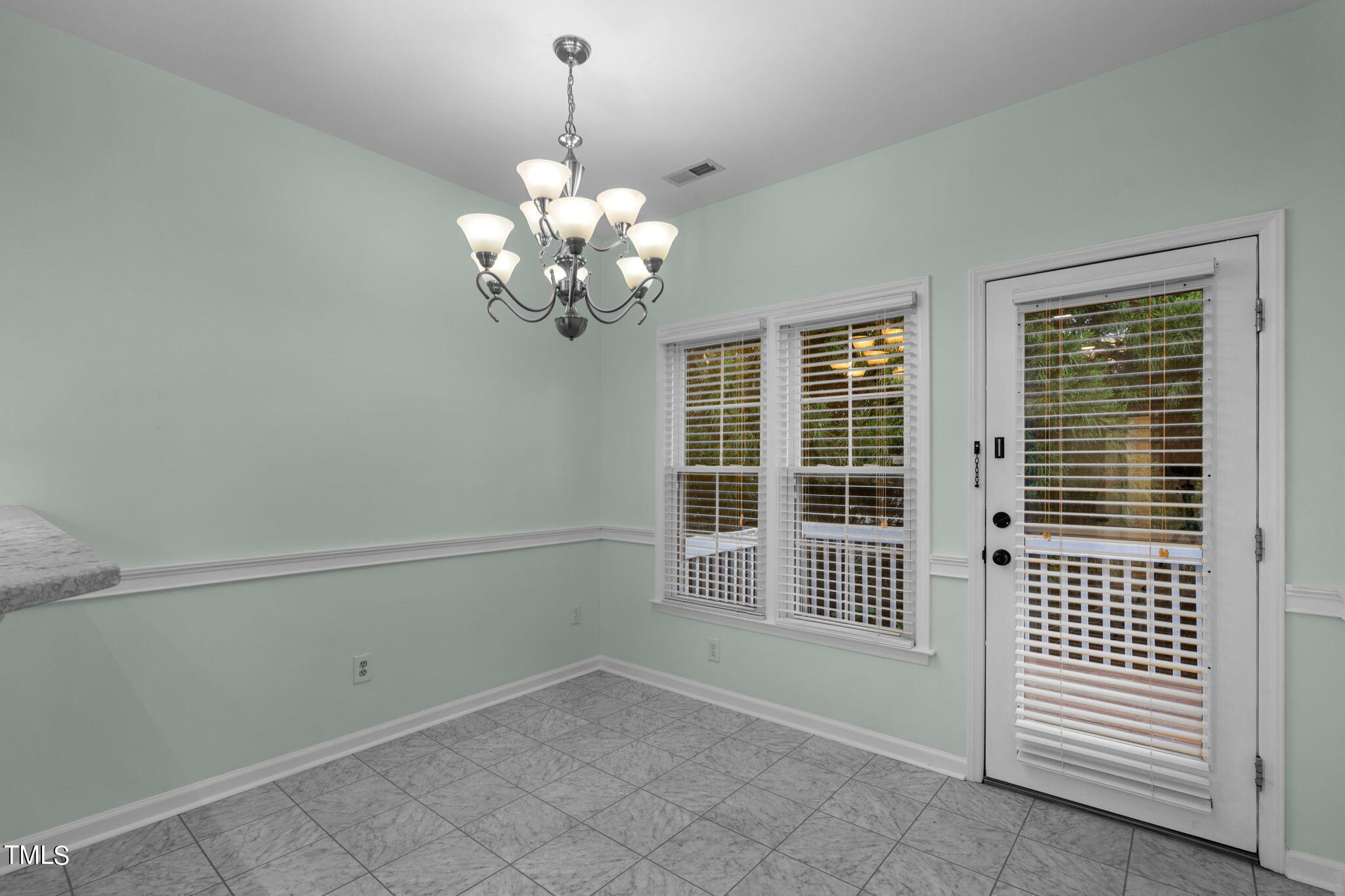 8241 Hempshire Place, Unit 102 Raleigh, NC 27613 - Photo 11 of 30 a view of a livingroom with a chandelier staircase and a window
