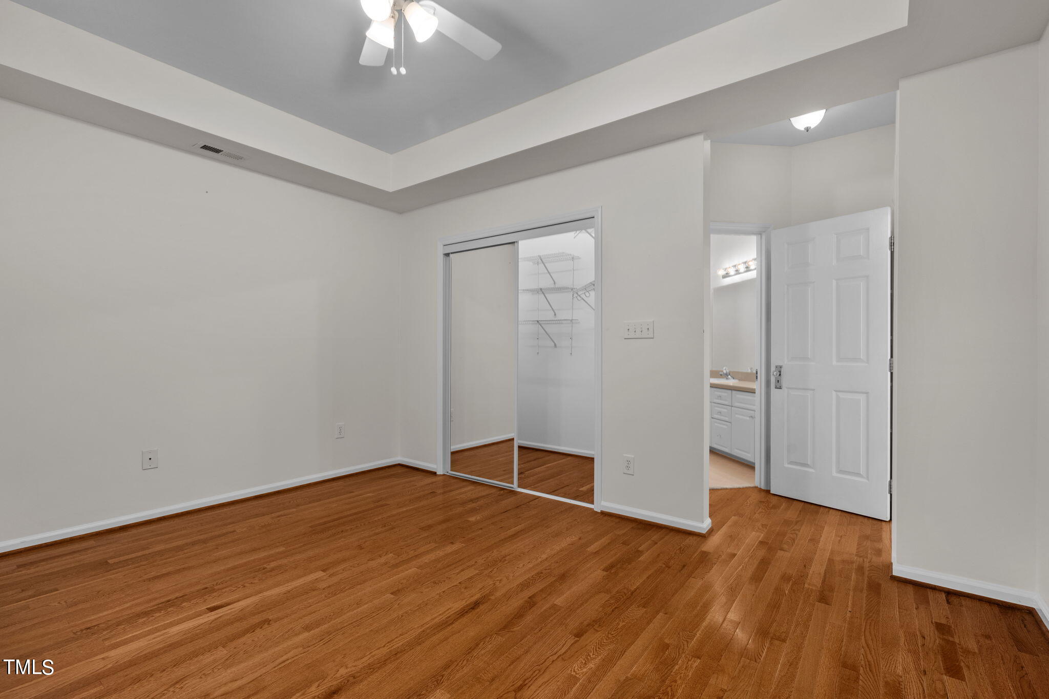 8241 Hempshire Place, Unit 102 Raleigh, NC 27613 - Photo 13 of 30 a view of empty room with wooden floor