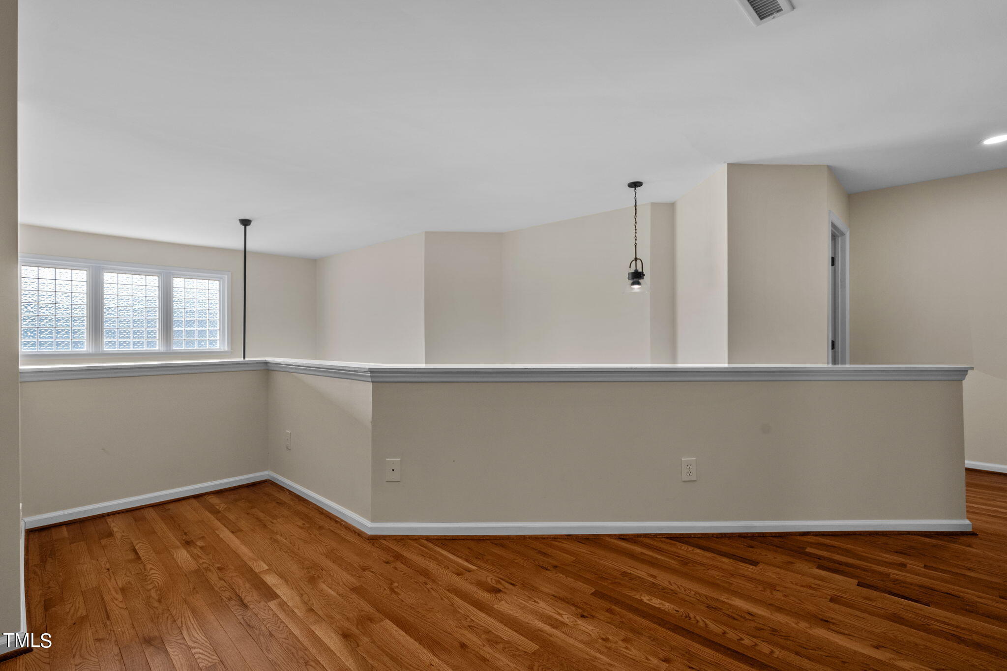 8241 Hempshire Place, Unit 102 Raleigh, NC 27613 - Photo 16 of 30 a view of a room with wooden floor and white walls