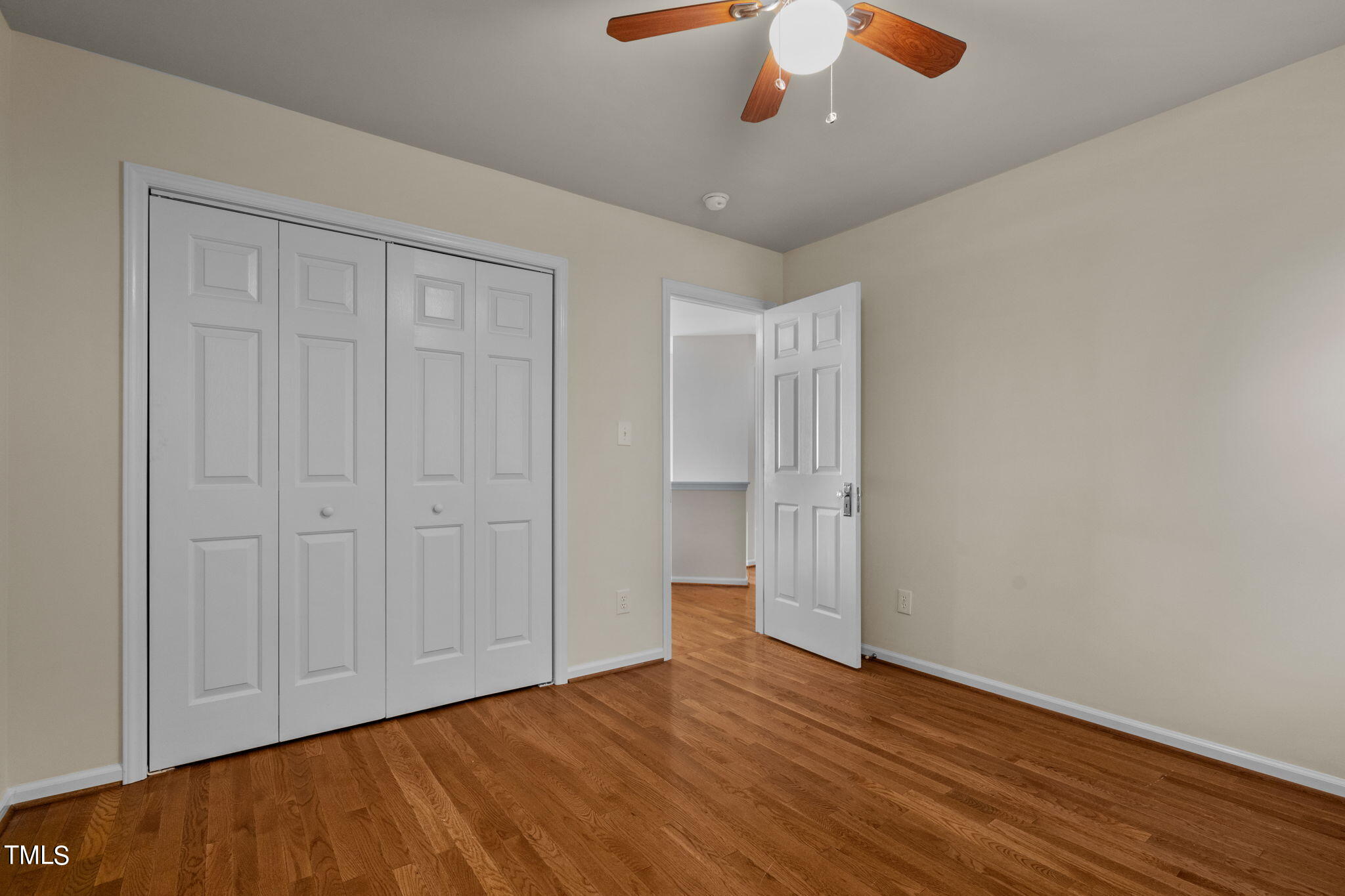 8241 Hempshire Place, Unit 102 Raleigh, NC 27613 - Photo 18 of 30 a view of an empty room with wooden floor