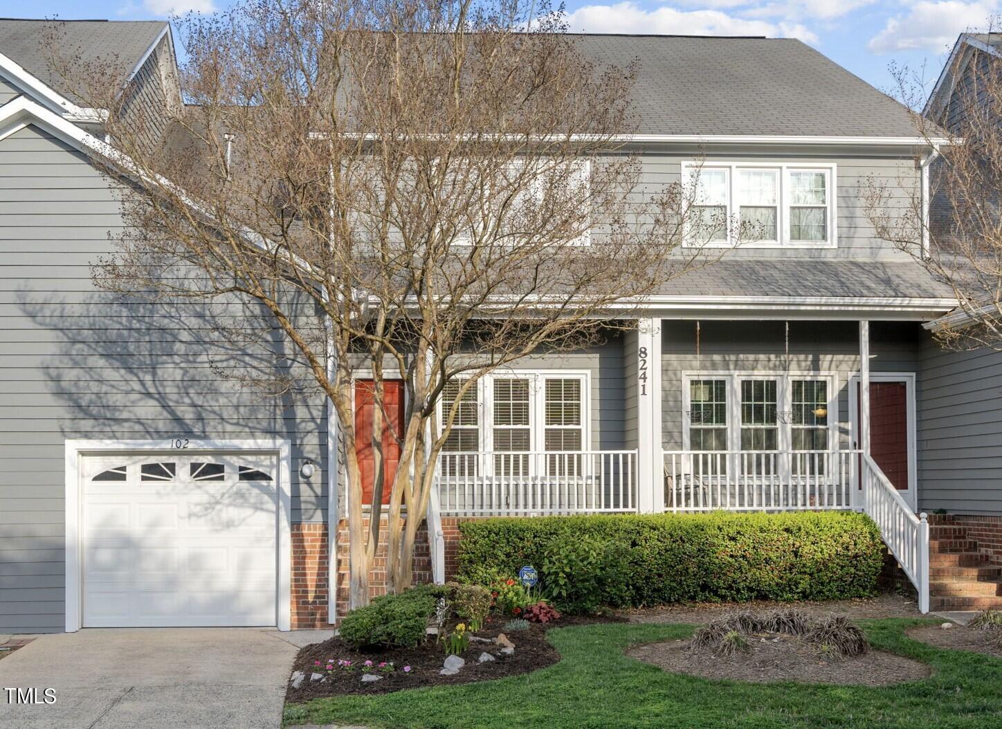 8241 Hempshire Place, Unit 102 Raleigh, NC 27613 - Photo 2 of 30 a front view of a house with garden