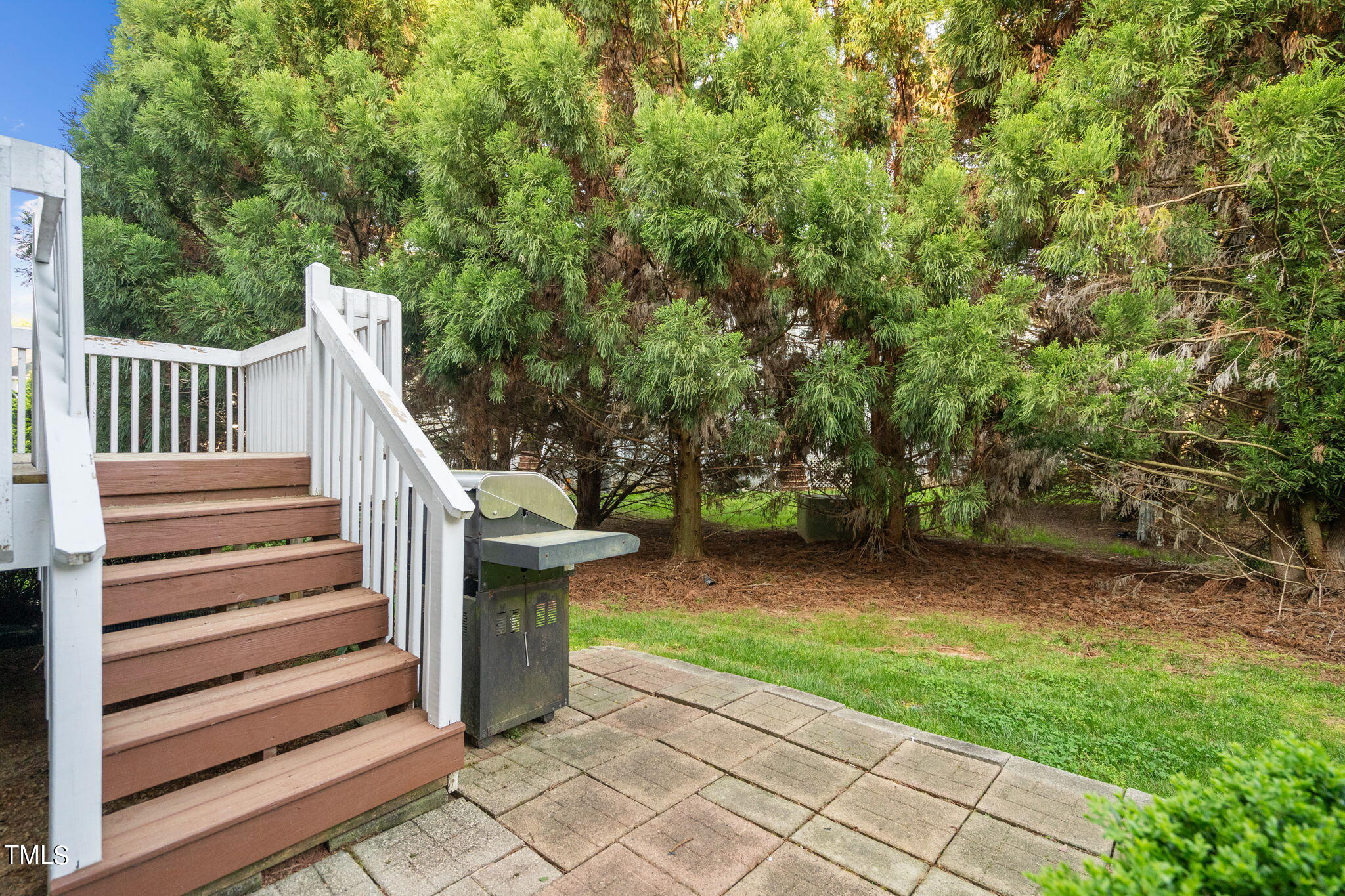 8241 Hempshire Place, Unit 102 Raleigh, NC 27613 - Photo 28 of 30 a view of a chair and table in the yard of the house