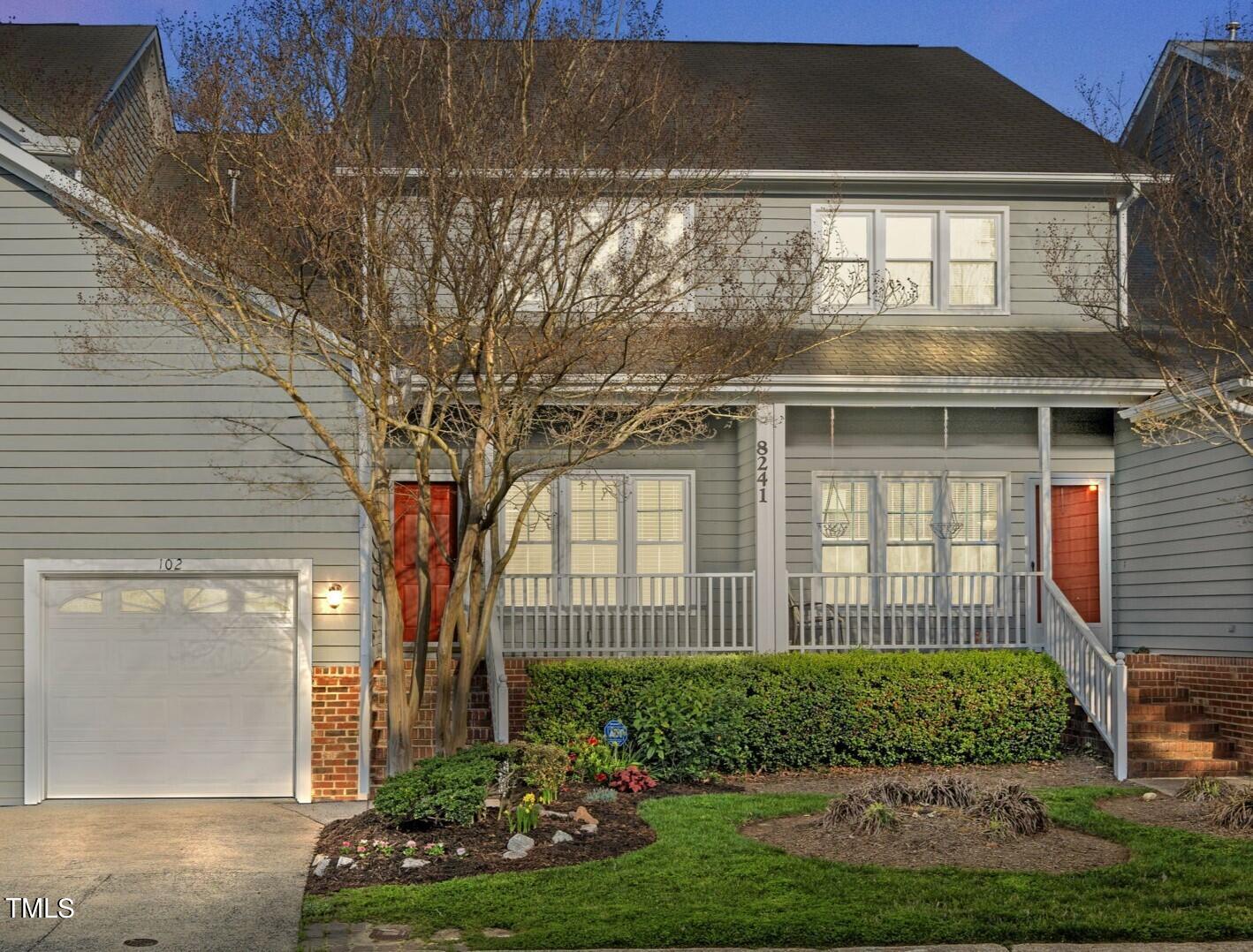 8241 Hempshire Place, Unit 102 Raleigh, NC 27613 - Photo 3 of 30 a front view of a house with a yard
