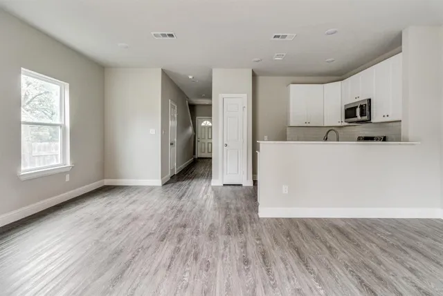 a view of a kitchen with a sink and a refrigerator