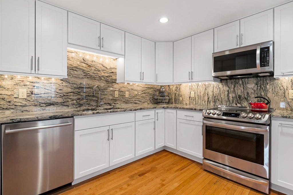 17 D Cold Spring Drive, Unit D Sutton, MA 01590 - Photo 12 of 20 a kitchen with white cabinets stainless steel appliances and sink
