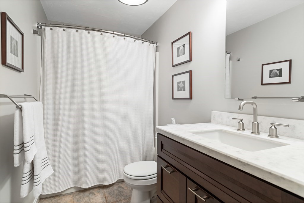 17 D Cold Spring Drive, Unit D Sutton, MA 01590 - Photo 13 of 20 a bathroom with a sink a toilet and a mirror