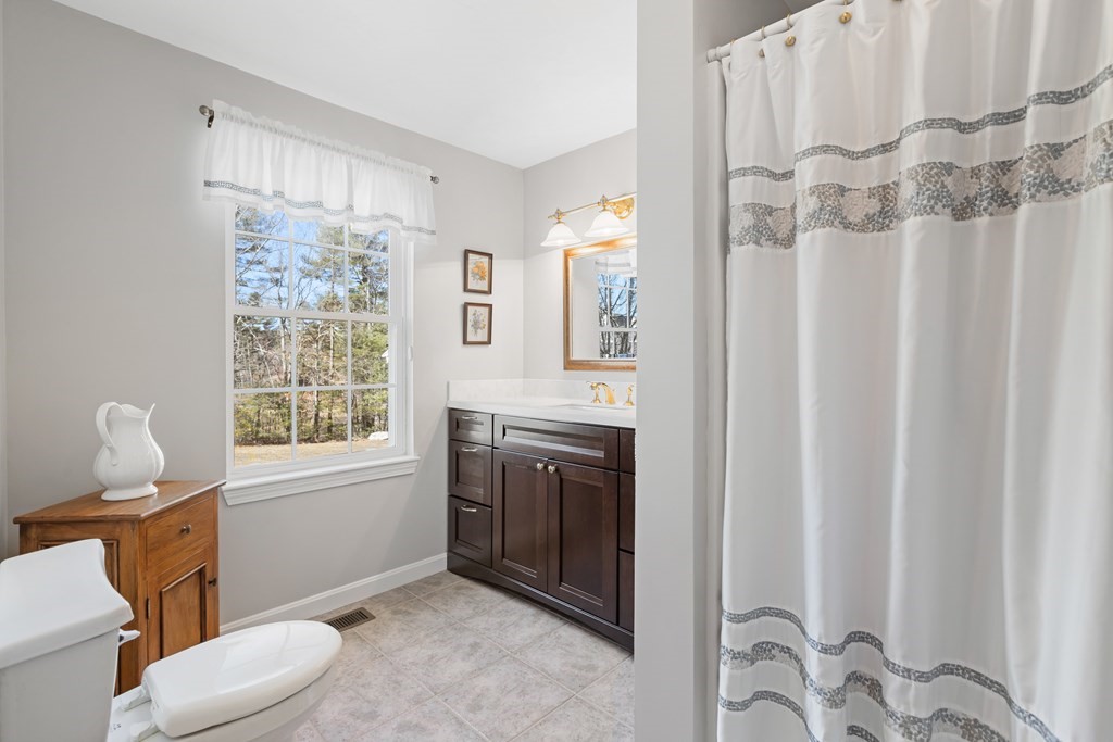 17 D Cold Spring Drive, Unit D Sutton, MA 01590 - Photo 15 of 20 a bathroom with a granite countertop sink toilet and shower