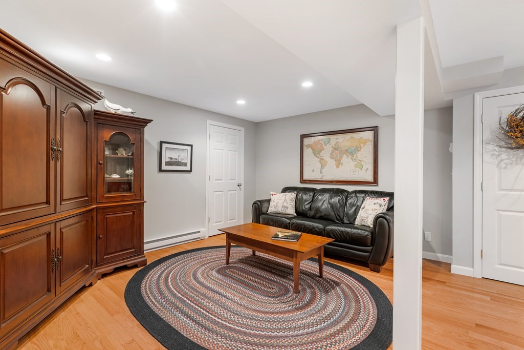 17 D Cold Spring Drive, Unit D Sutton, MA 01590 - Photo 19 of 20 a living room with furniture and a wooden floor