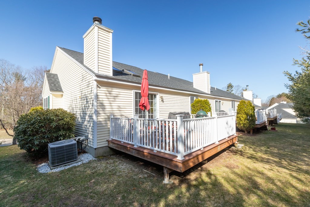 17 D Cold Spring Drive, Unit D Sutton, MA 01590 - Photo 3 of 20 a view of backyard with a deck