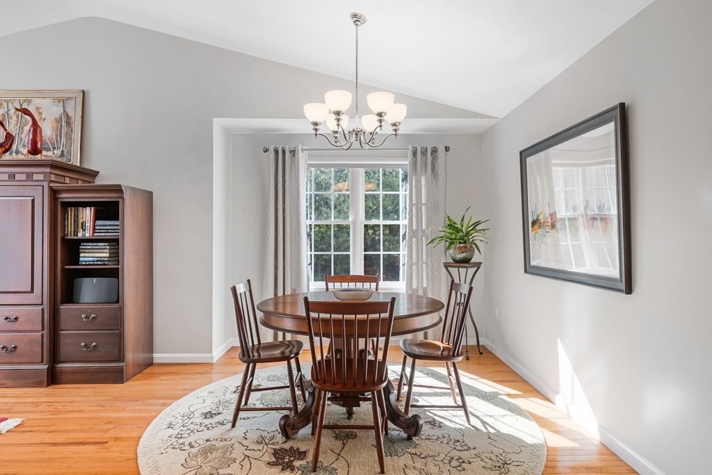 17 D Cold Spring Drive, Unit D Sutton, MA 01590 - Photo 9 of 20 a dining room with furniture a chandelier and wooden floor