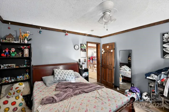 a bedroom with a bed a walk in closet and a mirror