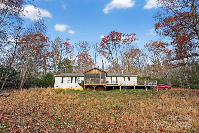 a view of a house with a yard and sitting area