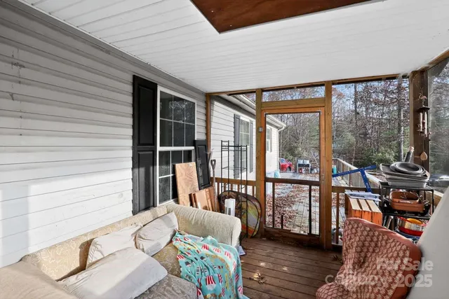 a living room filled with furniture and a floor to ceiling window
