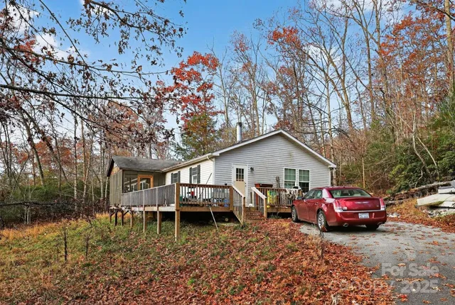 a view of a house with cars parked in front of it