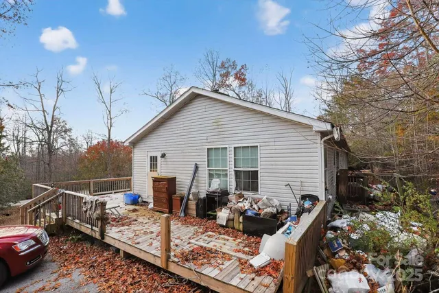 a view of backyard with outdoor seating and trees