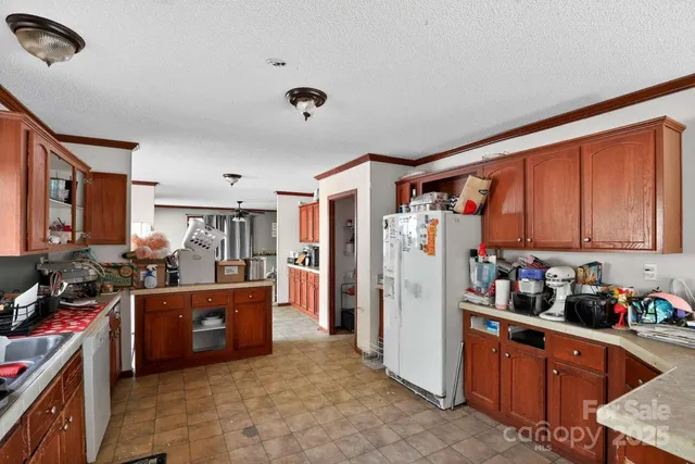 a kitchen with stainless steel appliances granite countertop a refrigerator and a stove