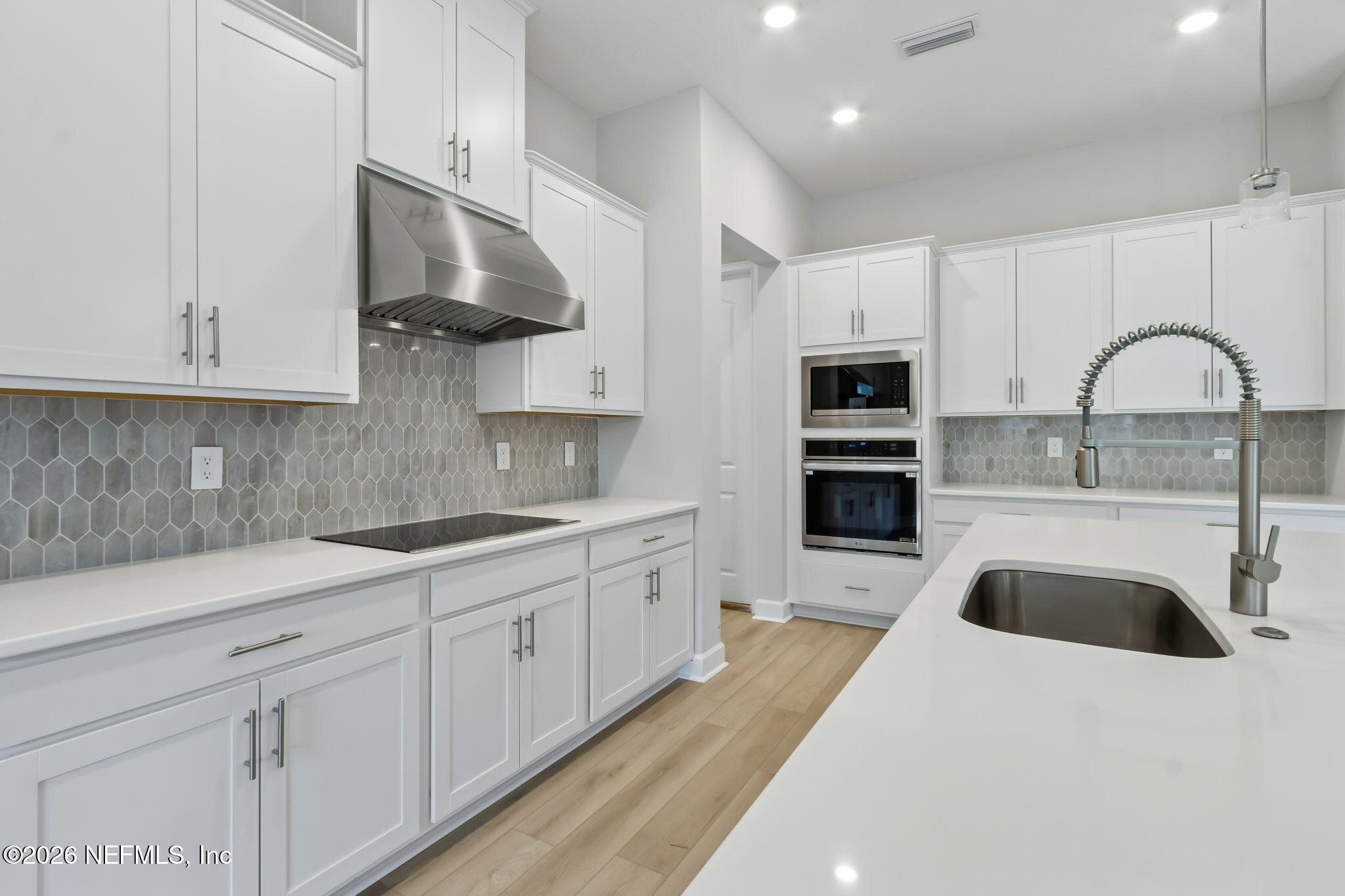 85350 Sandy Rdg Loop, Unit 39 Yulee, FL 32097 - Photo 10 of 29 a kitchen with stainless steel appliances granite countertop a sink a stove and refrigerator