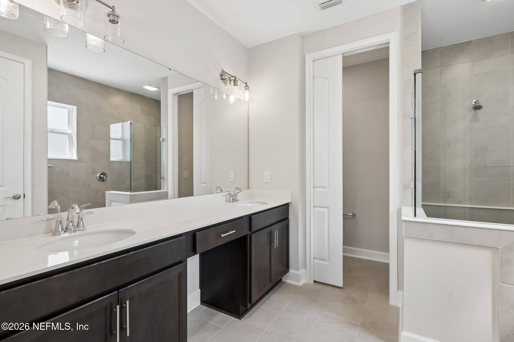 85350 Sandy Rdg Loop, Unit 39 Yulee, FL 32097 - Photo 15 of 29 a bathroom with a double vanity sink and mirror
