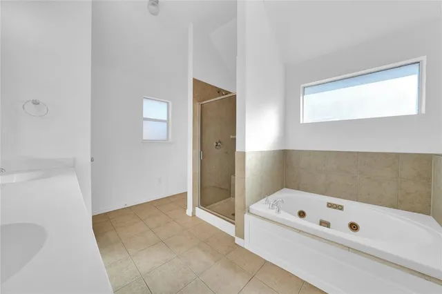 a bathroom with a bathtub and shower