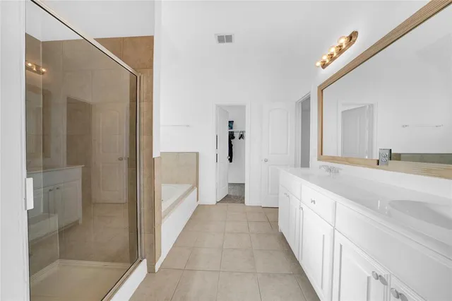 a bathroom with a granite countertop sink a mirror and a shower