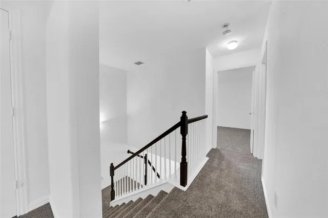 a view of a hallway with staircase