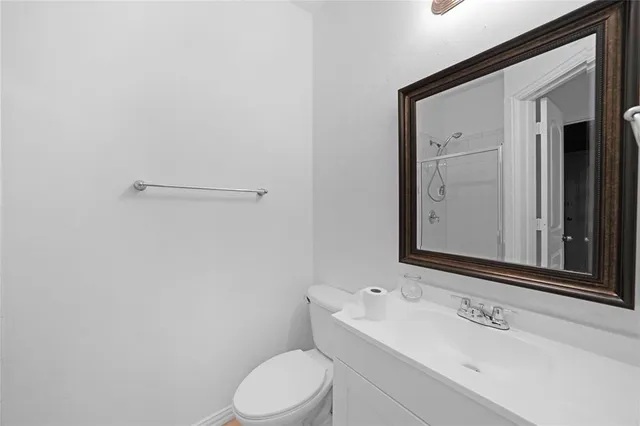 a bathroom with a sink a toilet and mirror