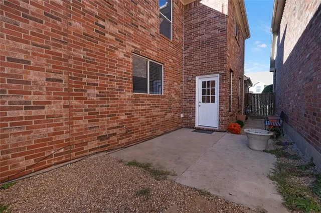 a view of a brick house with many windows