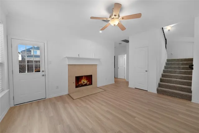 wooden floor in an empty room with a fireplace