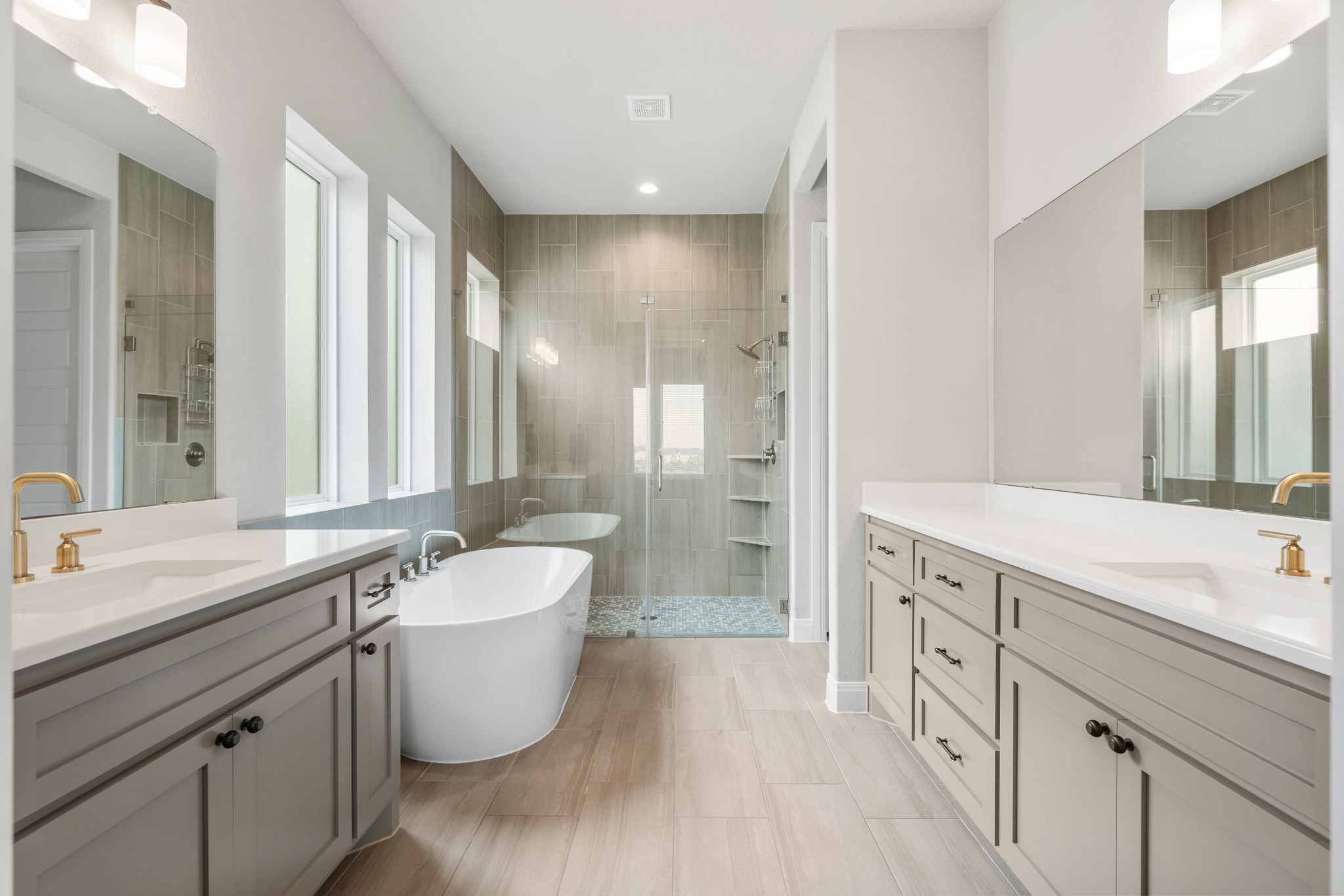510 Elworth Path Austin, TX 78738 - Photo 12 of 40 a bathroom with a double vanity sink a mirror and a bathtub