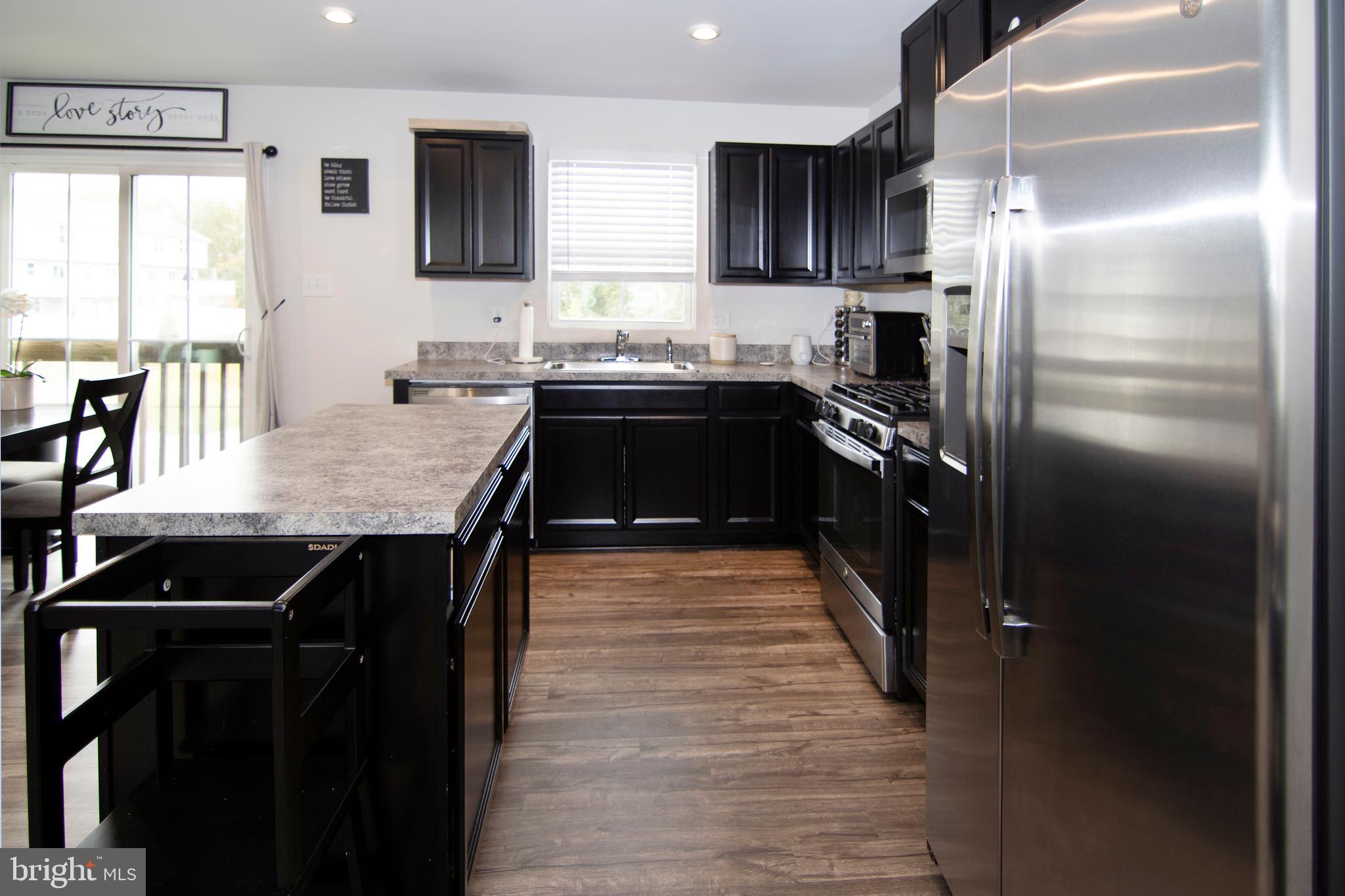 32 Burr Street Williamstown, NJ 08094 - Photo 12 of 34 a kitchen with stainless steel appliances granite countertop a sink stove and refrigerator