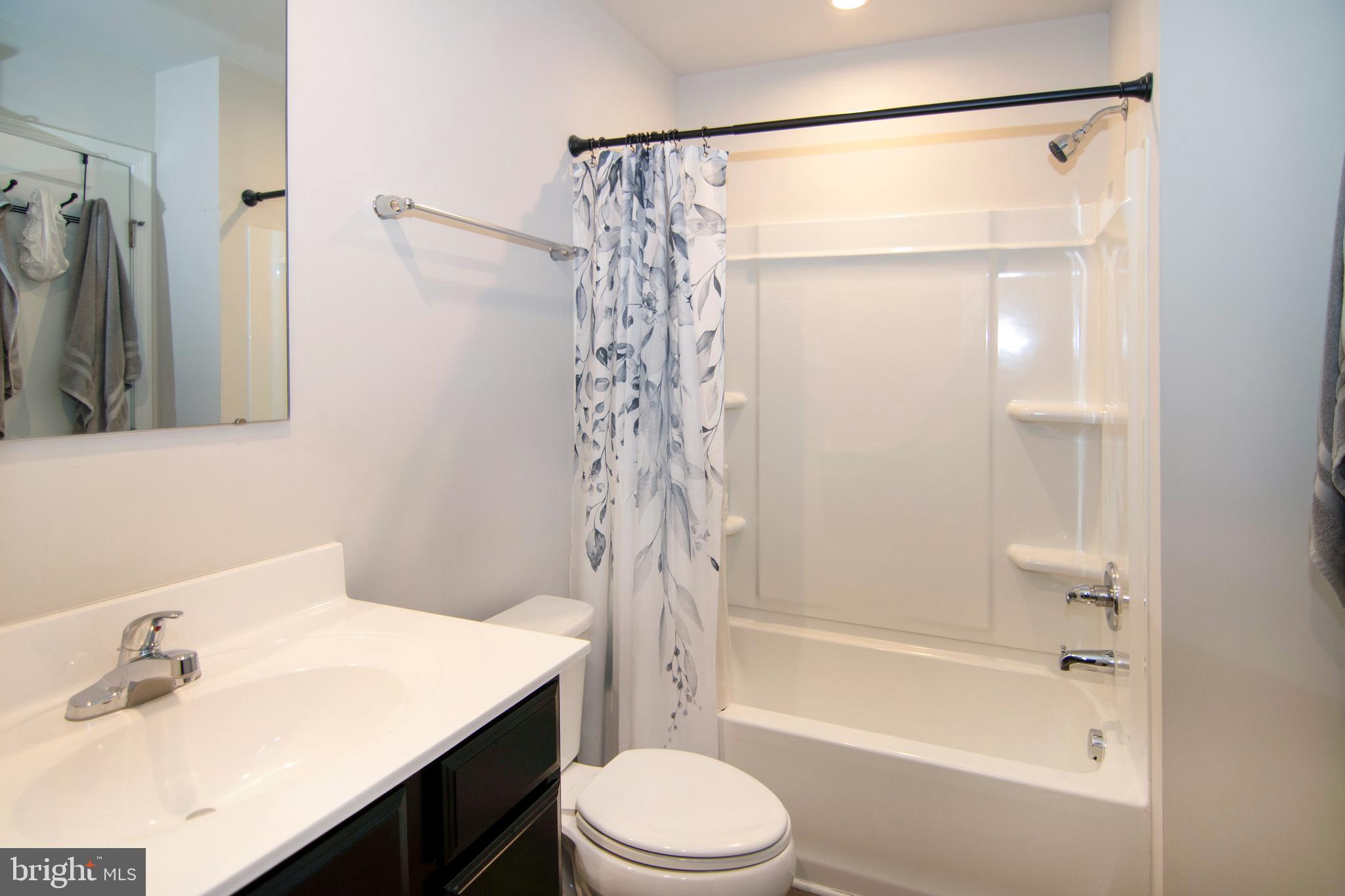 32 Burr Street Williamstown, NJ 08094 - Photo 20 of 34 a bathroom with a bathtub shower sink vanity and toilet