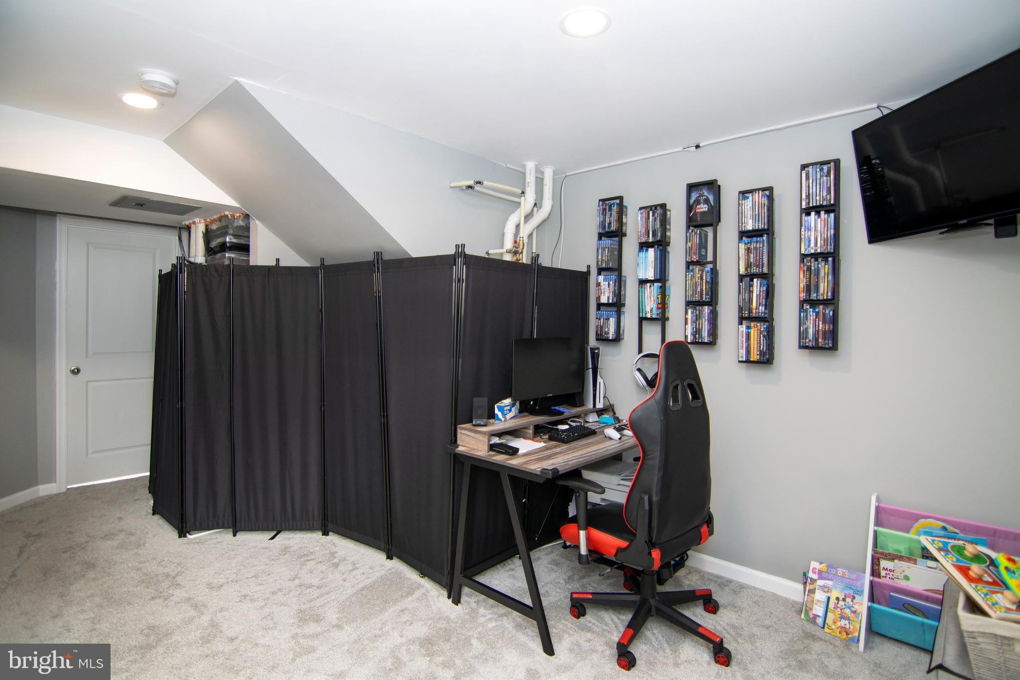 32 Burr Street Williamstown, NJ 08094 - Photo 31 of 34 a room with furniture a flat screen tv and gym equipment