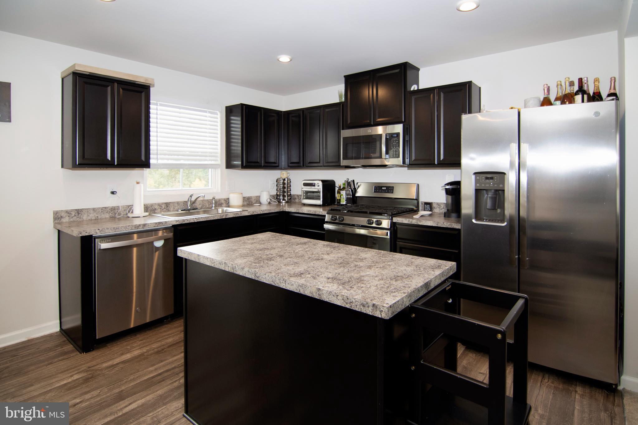 32 Burr Street Williamstown, NJ 08094 - Photo 10 of 34 a kitchen with stainless steel appliances granite countertop a sink stove and refrigerator