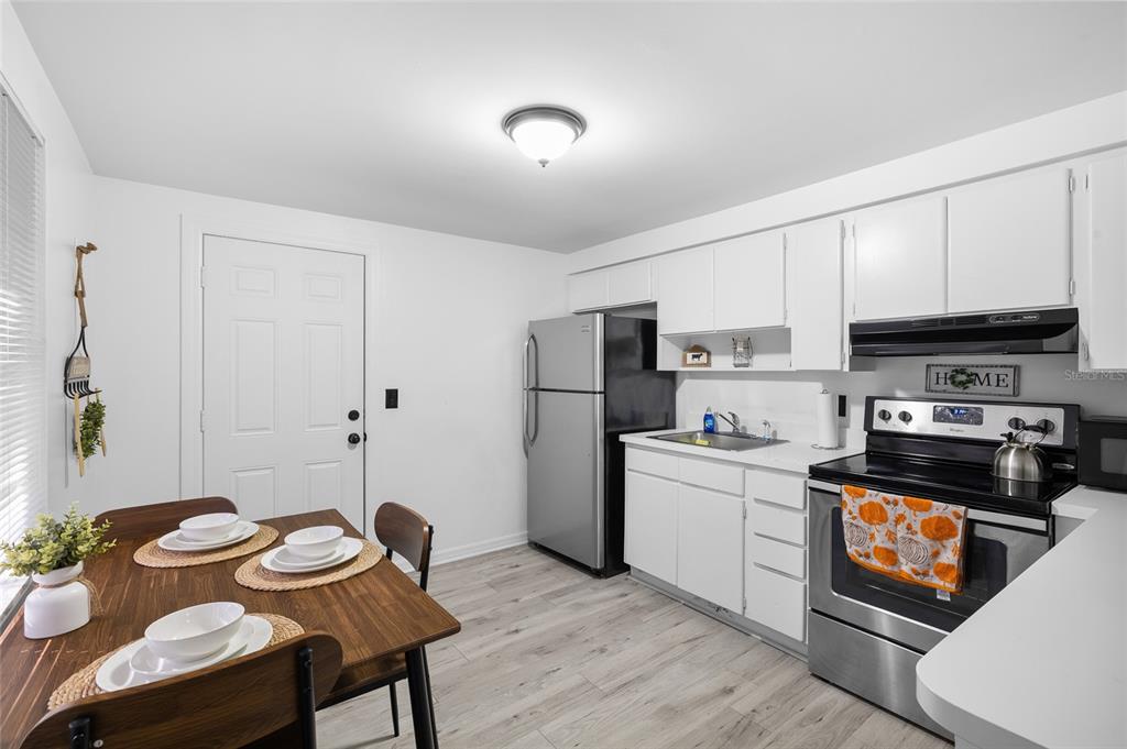 1220 East 142nd Avenue Tampa, FL 33613 - Photo 12 of 36 a kitchen with a sink a stove and refrigerator