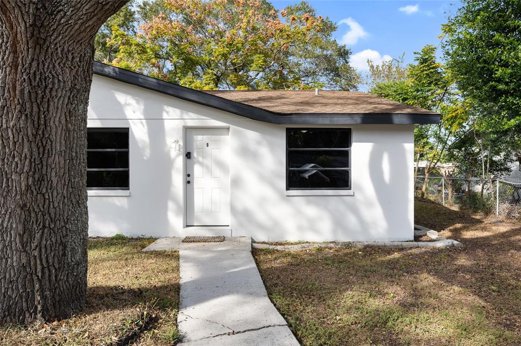 1220 East 142nd Avenue Tampa, FL 33613 - Photo 17 of 36 a front view of a house with a yard
