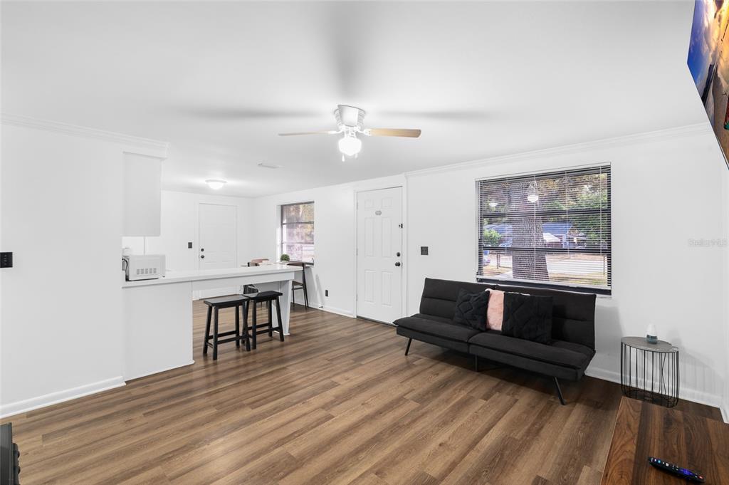 1220 East 142nd Avenue Tampa, FL 33613 - Photo 21 of 36 a living room with furniture and wooden floor