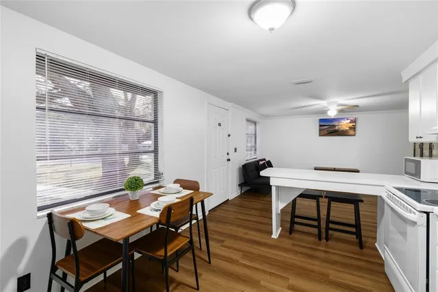 a view of a workspace with furniture and a table in it