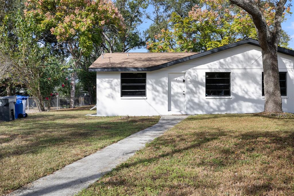 1220 East 142nd Avenue Tampa, FL 33613 - Photo 5 of 36 a front view of a house with garden