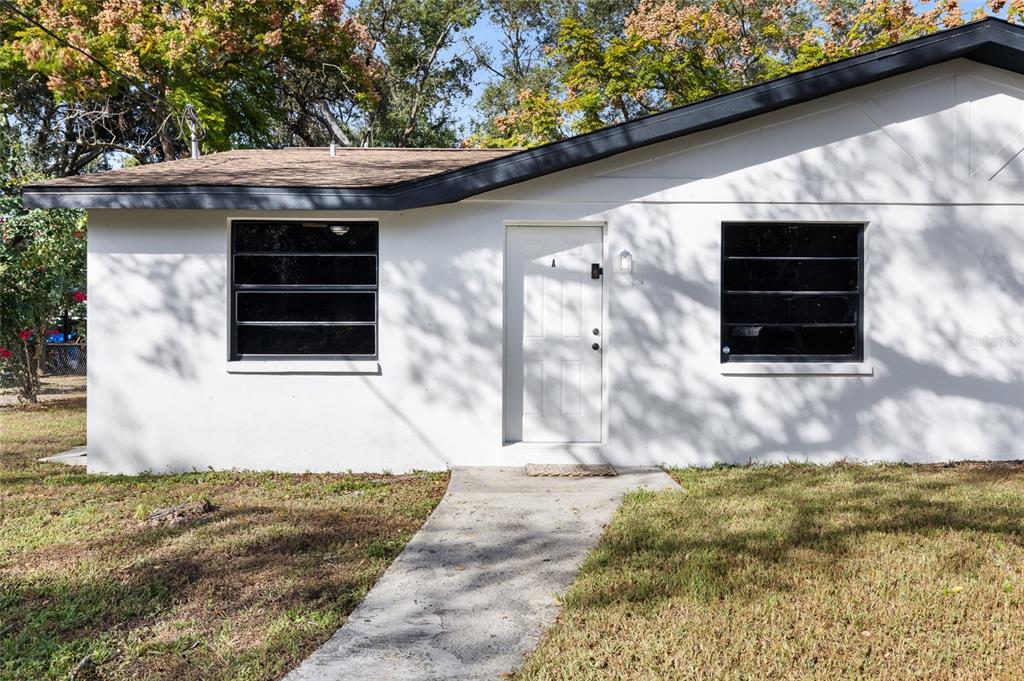 1220 East 142nd Avenue Tampa, FL 33613 - Photo 6 of 36 a front view of a house with garden